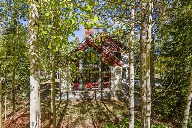 a living room with furniture a large window and potted plants