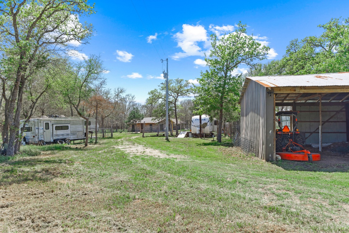 445 St Johns Road Dale, TX 78616 - Photo 3 of 17 a backyard of a house with lots of green space and fountain