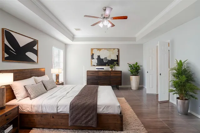 a bedroom with a bed and a potted plant