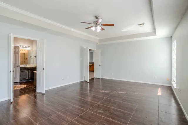 wooden floor in an empty room and a bathroom