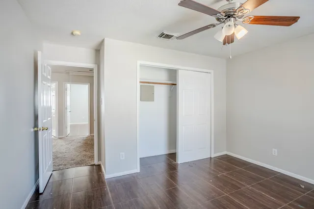 wooden floor in an empty room with a bathroom
