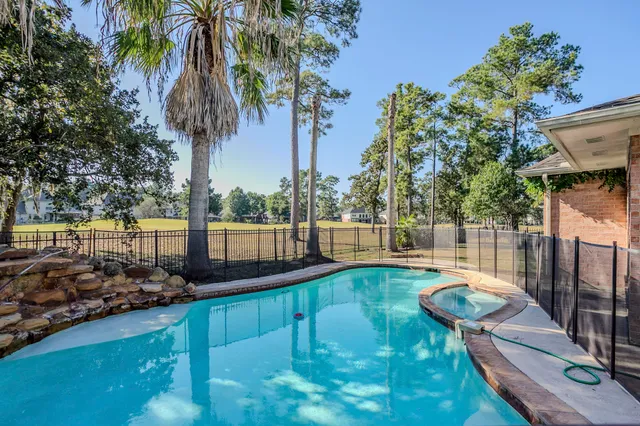 a view of a backyard with swimming pool