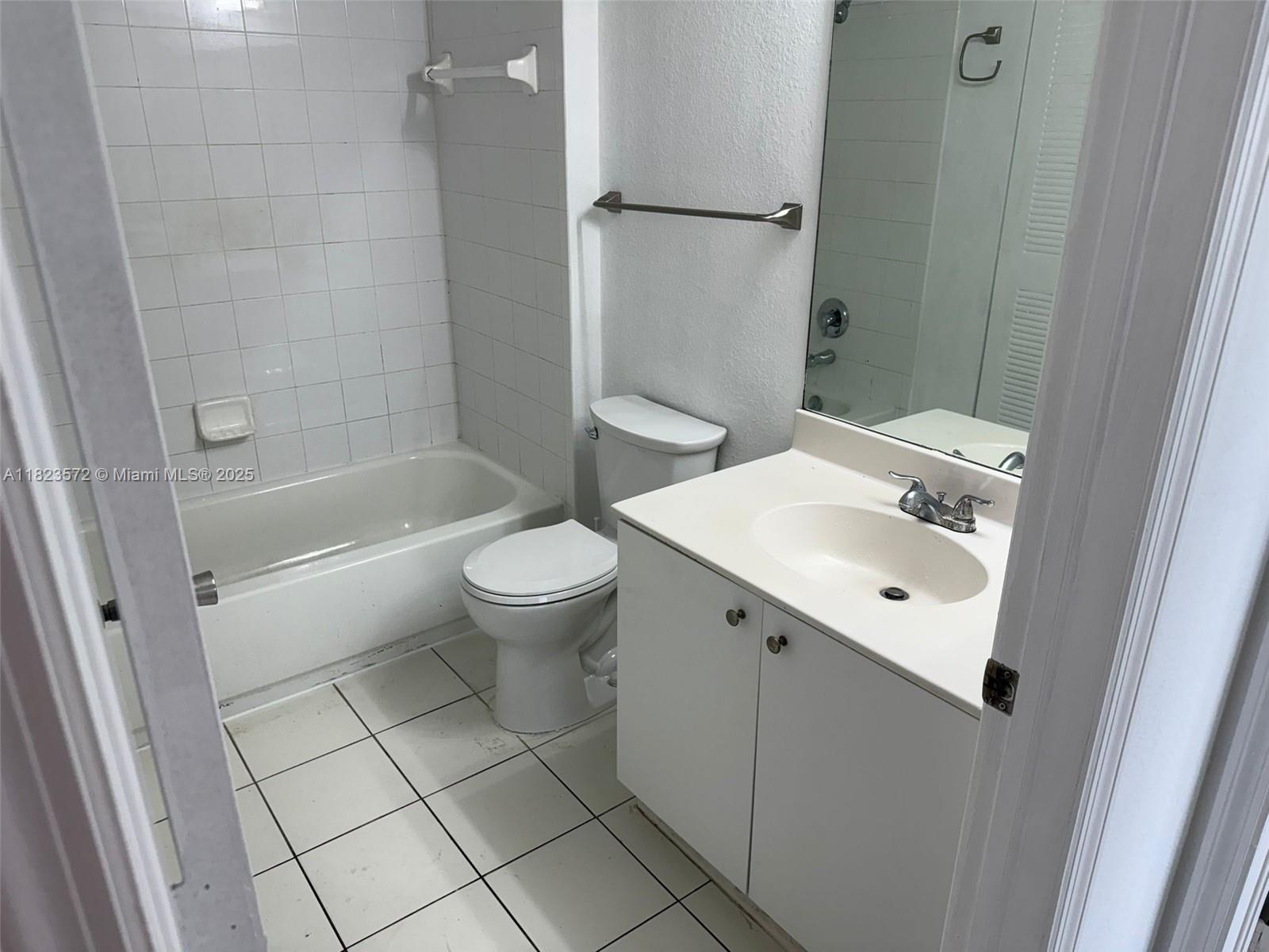 15422 Southwest 284th Street, Unit 7207 Homestead, FL 33033 - Photo 13 of 36 a bathroom with a sink a toilet and shower