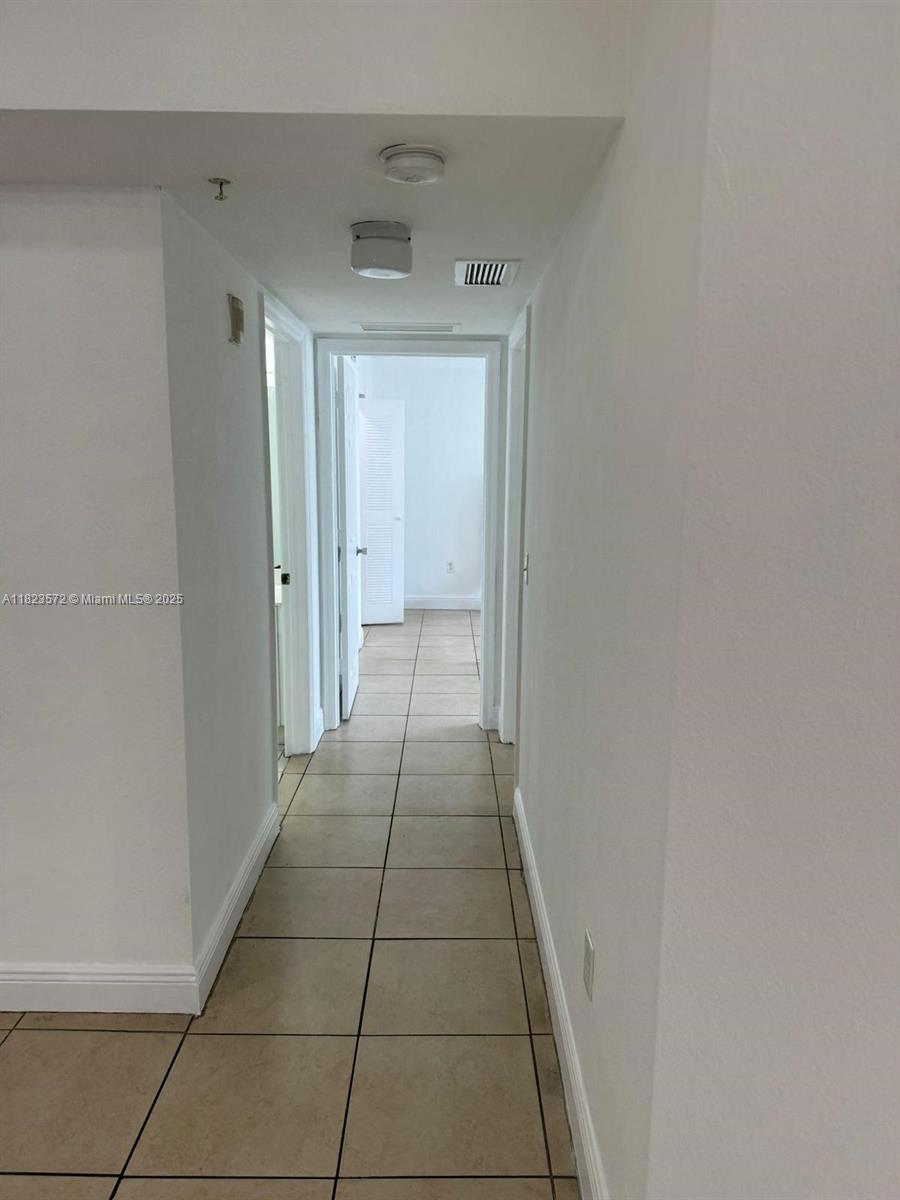 15422 Southwest 284th Street, Unit 7207 Homestead, FL 33033 - Photo 17 of 36 a hallway view with a wooden floor