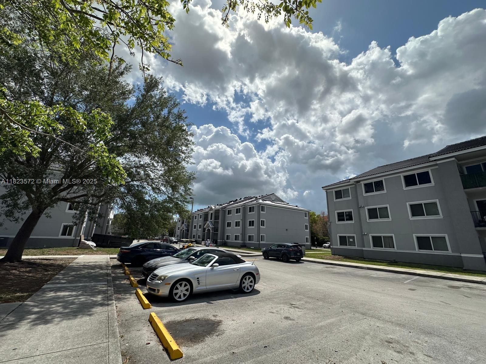 15422 Southwest 284th Street, Unit 7207 Homestead, FL 33033 - Photo 27 of 36 a view of street with parked cars