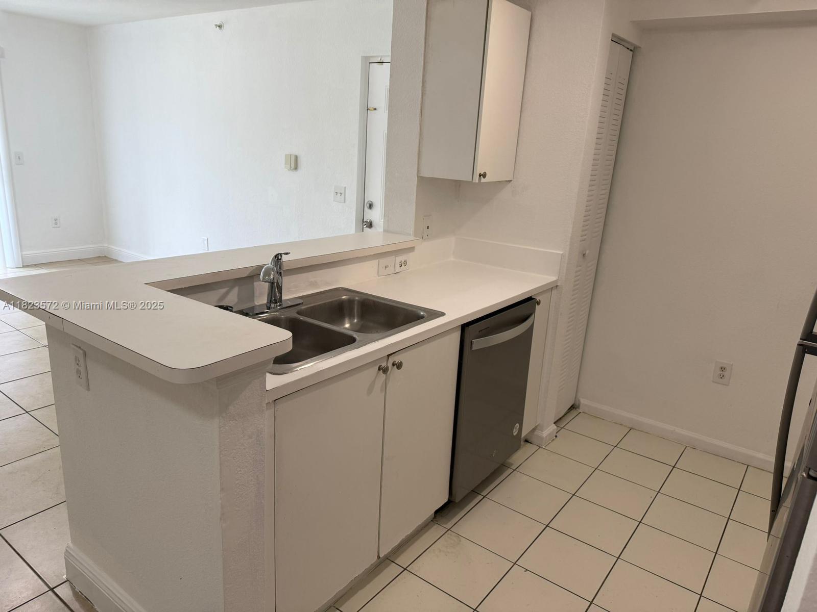 15422 Southwest 284th Street, Unit 7207 Homestead, FL 33033 - Photo 7 of 36 a utility room with cabinets washer and dryer