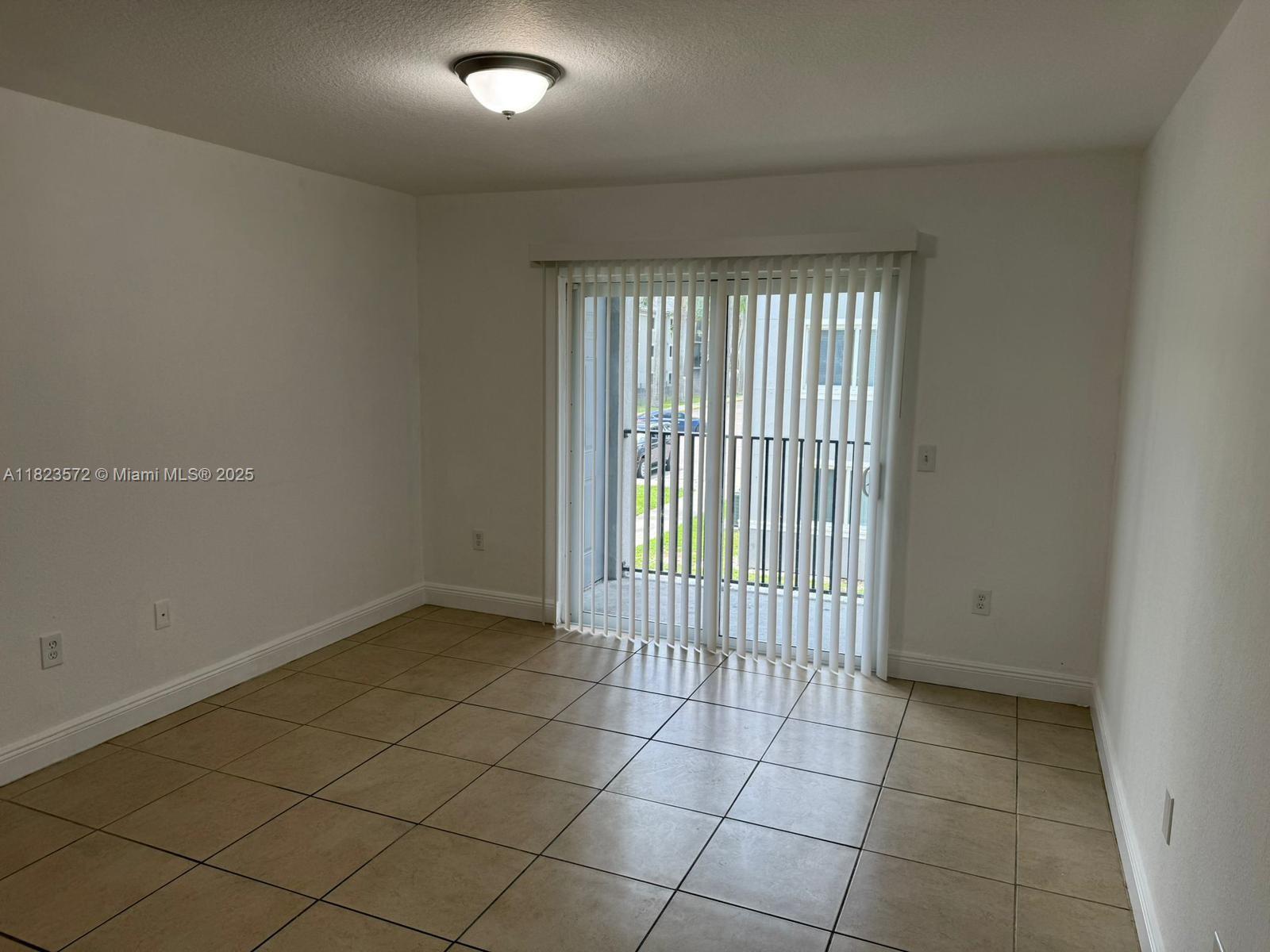 15422 Southwest 284th Street, Unit 7207 Homestead, FL 33033 - Photo 10 of 36 a view of an empty room with a window