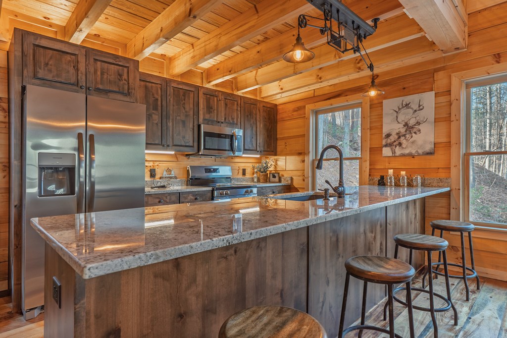 138 Rhondas Way Ellijay, GA 30540 - Photo 4 of 26 a kitchen with stainless steel appliances granite countertop a sink a stove and refrigerator