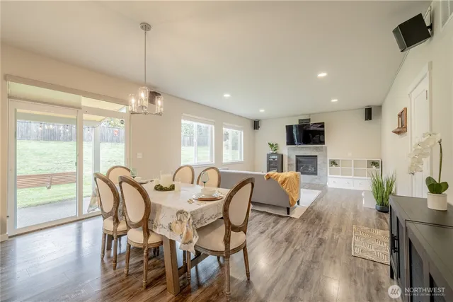 a view of a dining room with furniture wooden floor and chandelier