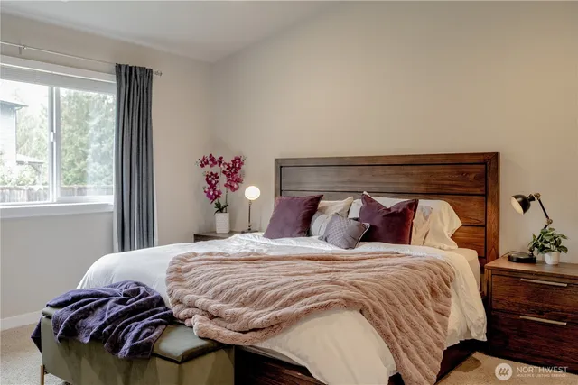 a bedroom with a bed and a potted plant