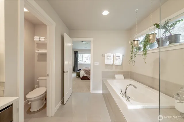 a spacious bathroom with a tub shower and toilet