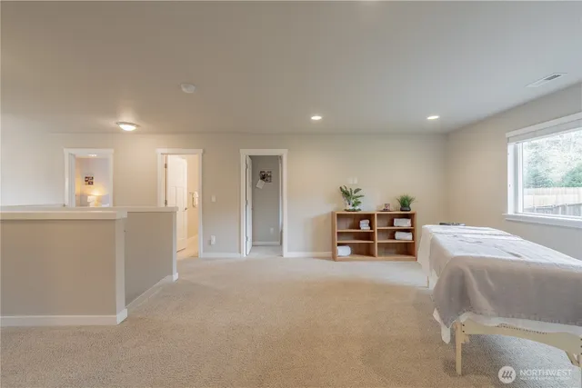 a room with furniture and a dining table with kitchen view