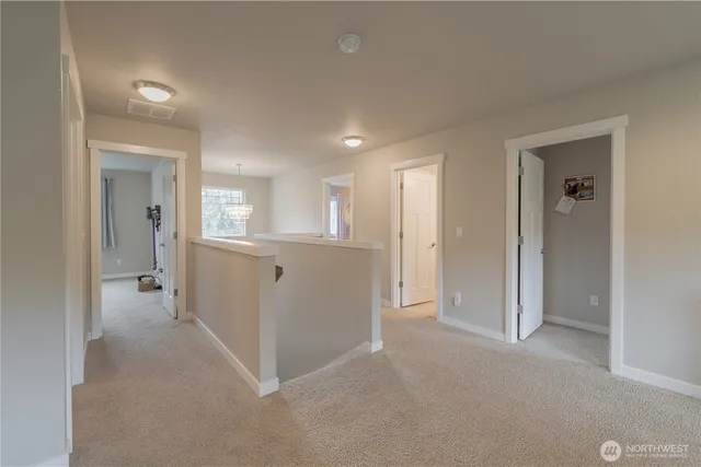 a view of a hallway with wooden shelves
