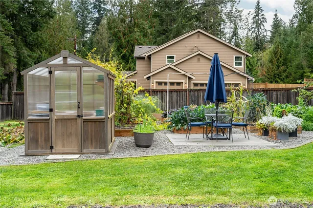 a front view of a house with a garden and plants