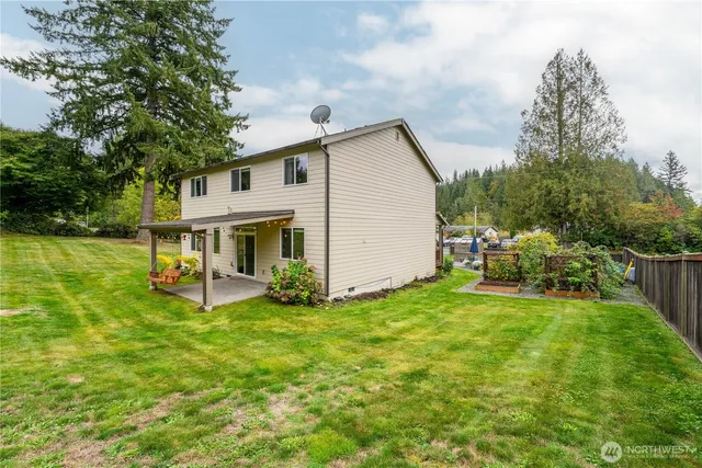 a view of a house with a yard and sitting area