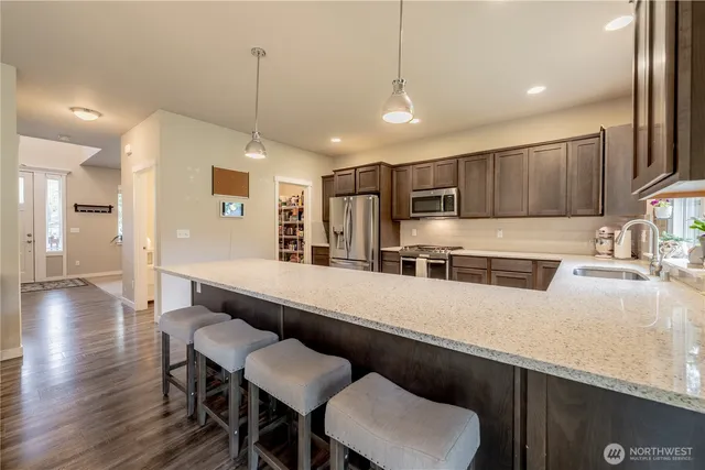 a large kitchen with a table and chairs