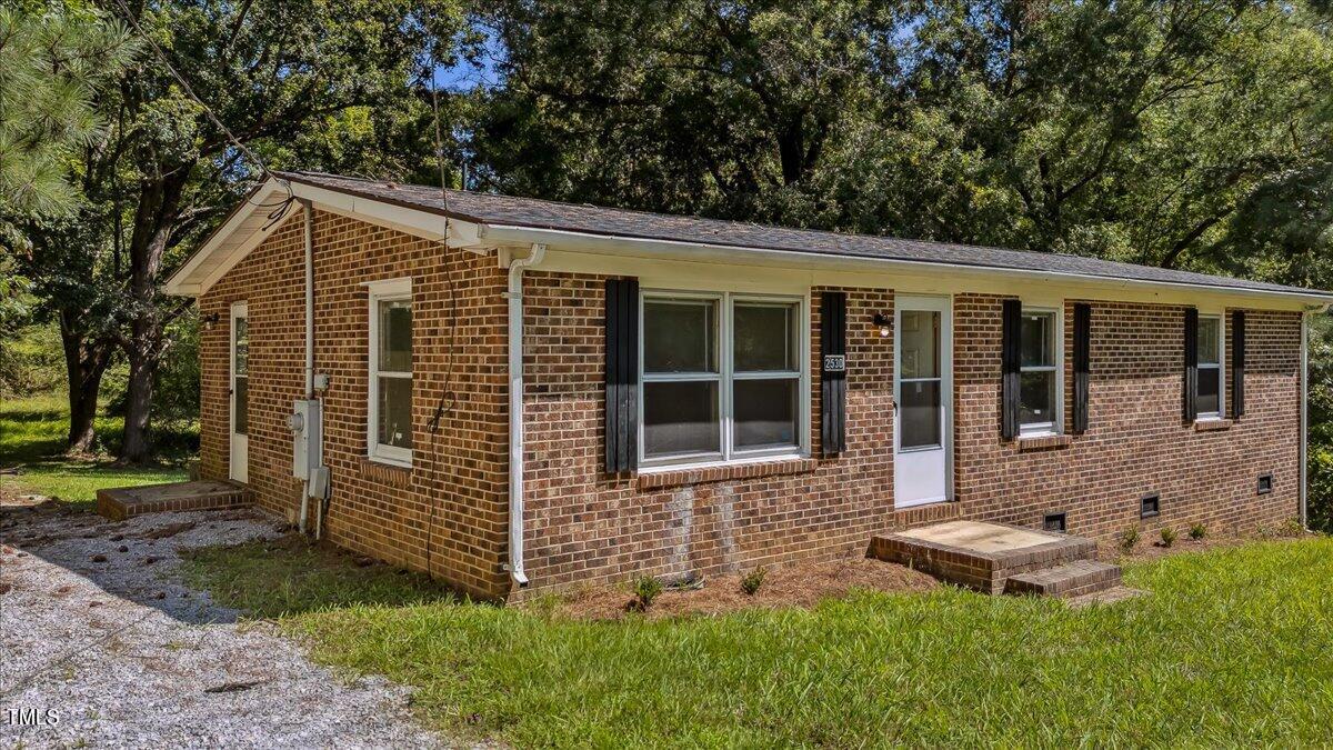 2530 Spring Valley Road Henderson, NC 27537 - Photo 1 of 45 a front view of a house with garden