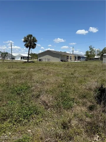 a view of a big yard with a house