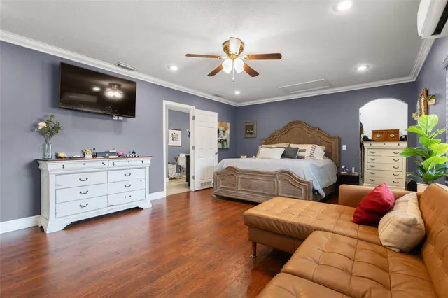 a bedroom with furniture and a flat screen tv