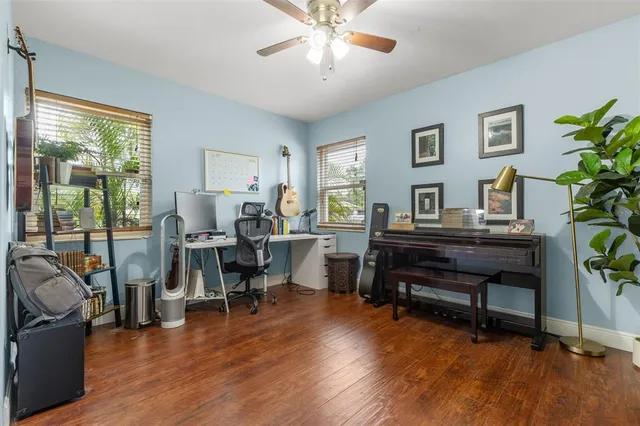 a living room with furniture and a wooden floor