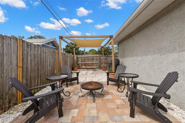 a view of a patio with a table and chairs under an umbrella