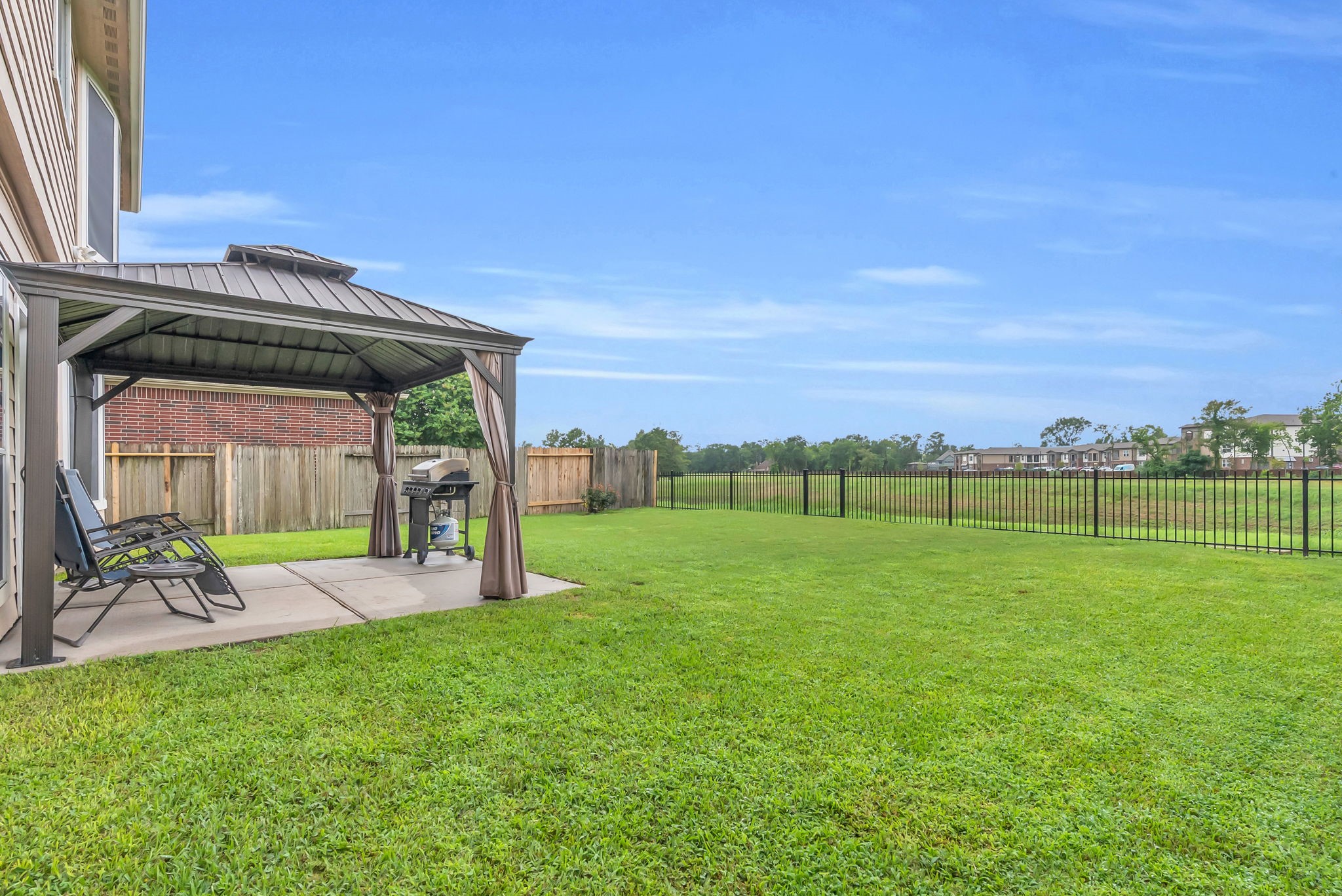 16619 Dover Mills Drive Spring, TX 77379 - Photo 38 of 49 a view of a backyard with table and chairs with wooden fence