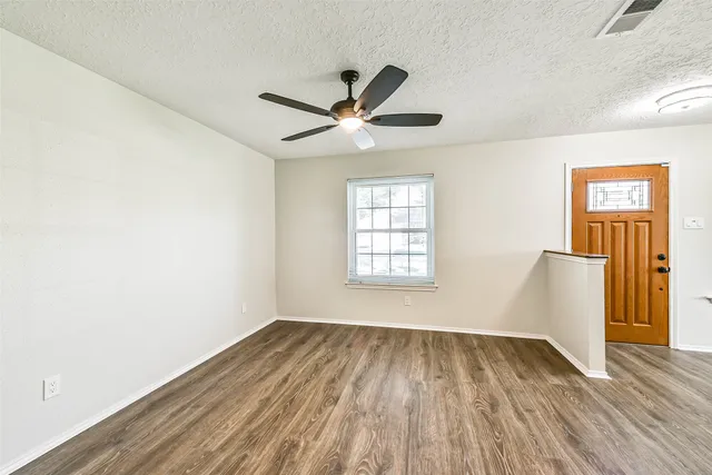 wooden floor in an empty room with a window