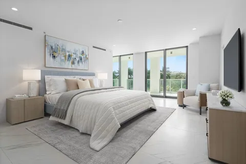a bedroom with a large bed and a chandelier