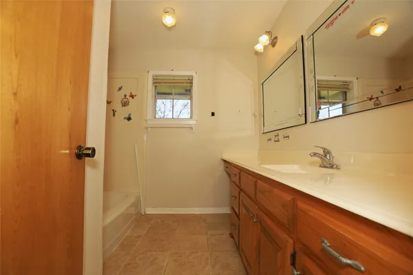a bathroom with a sink a vanity and mirror