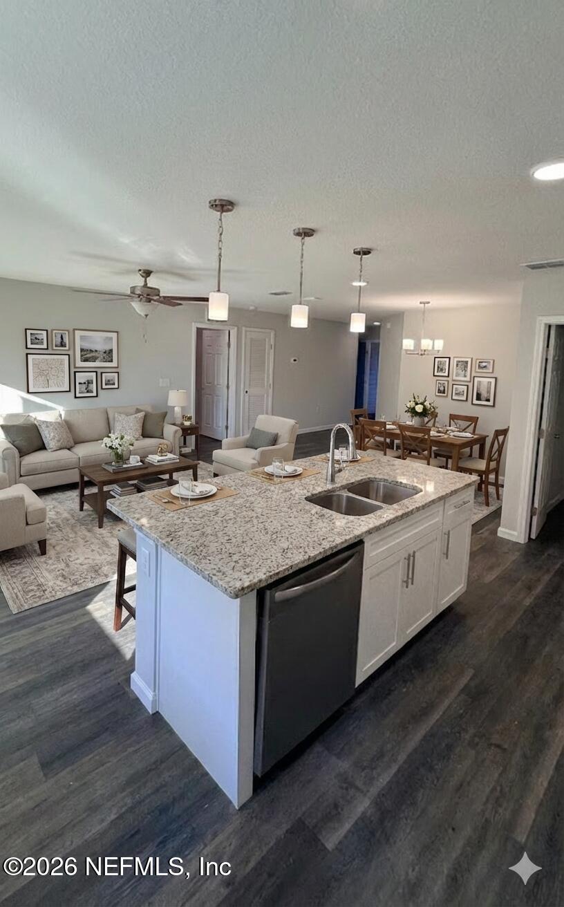 1082 Cahoon Road South Jacksonville, FL 32221 - Photo 3 of 9 a kitchen with stainless steel appliances granite countertop a sink stove and wooden cabinets