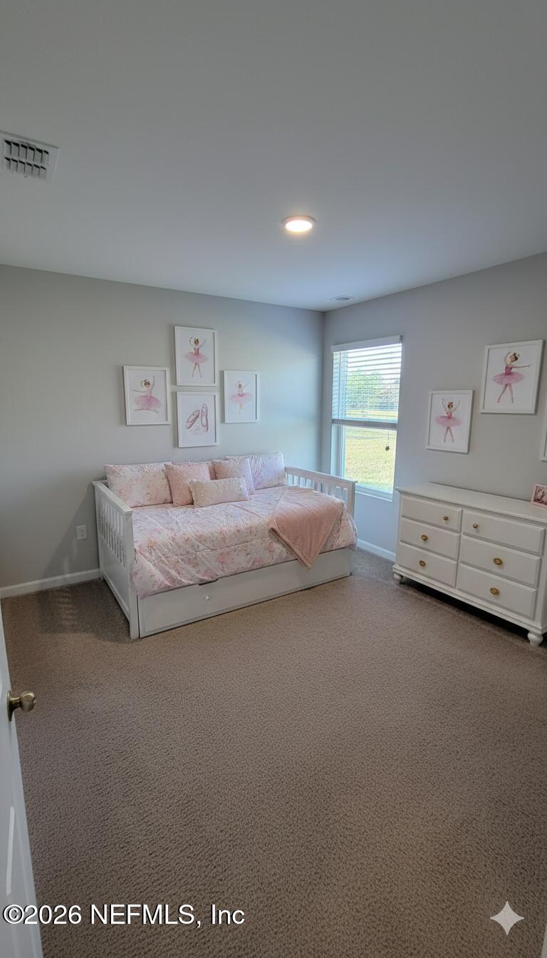 1082 Cahoon Road South Jacksonville, FL 32221 - Photo 7 of 9 a spacious bedroom with a bed and a window