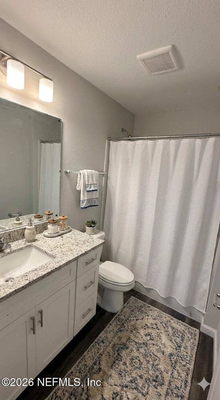 1082 Cahoon Road South Jacksonville, FL 32221 - Photo 9 of 9 a bathroom with a granite countertop sink toilet and shower