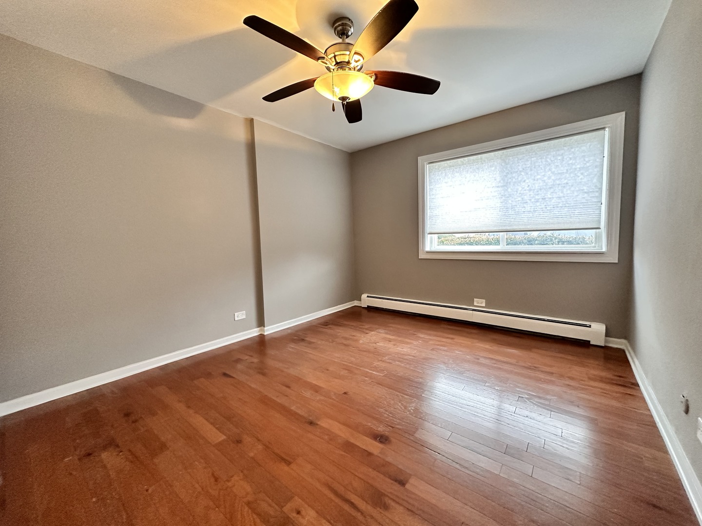 10357 Dearlove Road, Unit 1K Glenview, IL 60025 - Photo 13 of 24 an empty room with wooden floor and windows