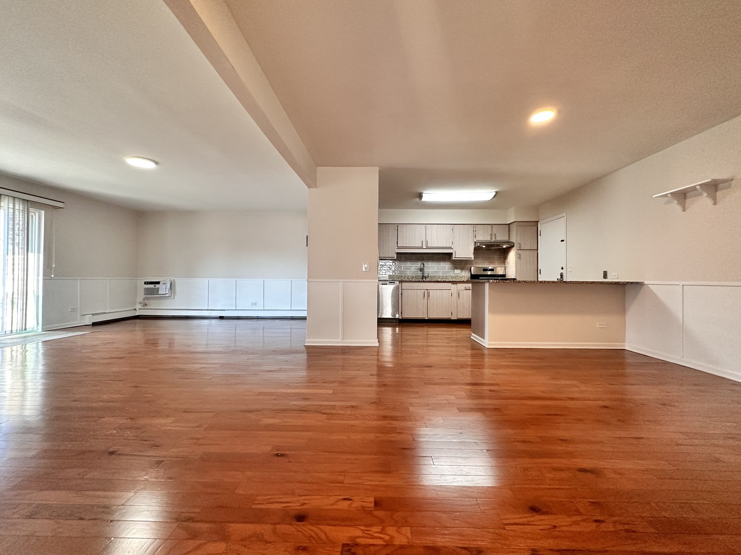 10357 Dearlove Road, Unit 1K Glenview, IL 60025 - Photo 5 of 24 a view of a kitchen with kitchen island a sink wooden floor and a stove top oven