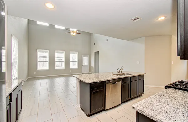 a kitchen with a sink and a stove top oven