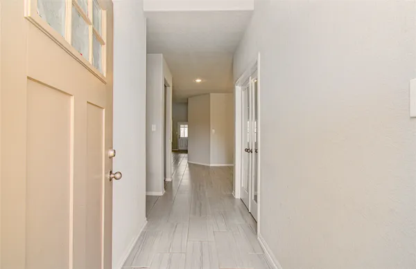 a view of a hallway with wooden floor