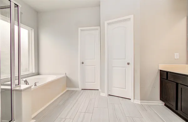 a bathroom with a bathtub and a shower