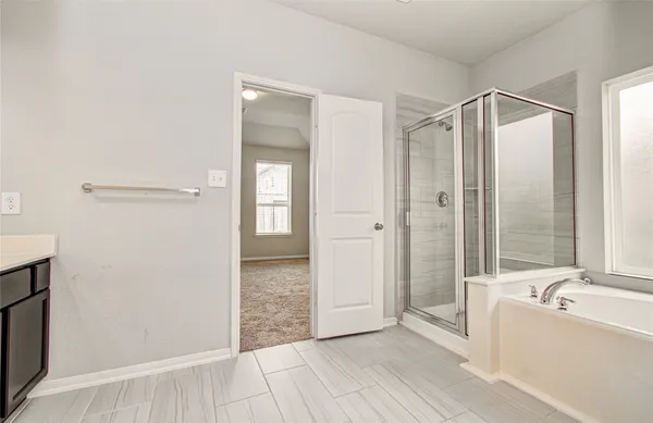 a bathroom with a bathtub and a shower