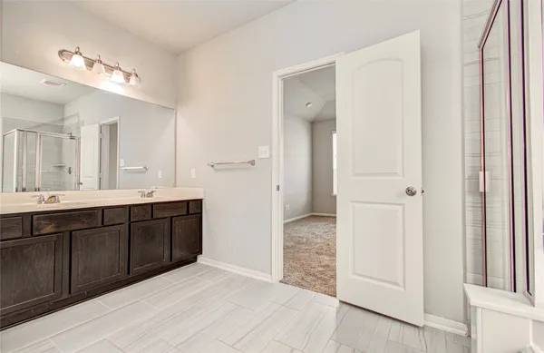 a spacious bathroom with a sink and a mirror