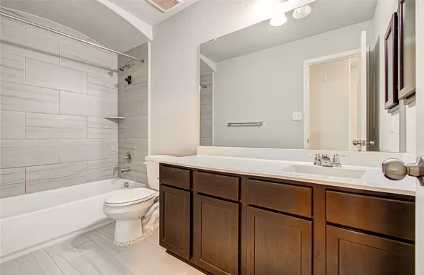a bathroom with a sink toilet tub and shower