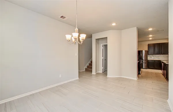 a view of a livingroom with a furniture nad kitchen chandelier