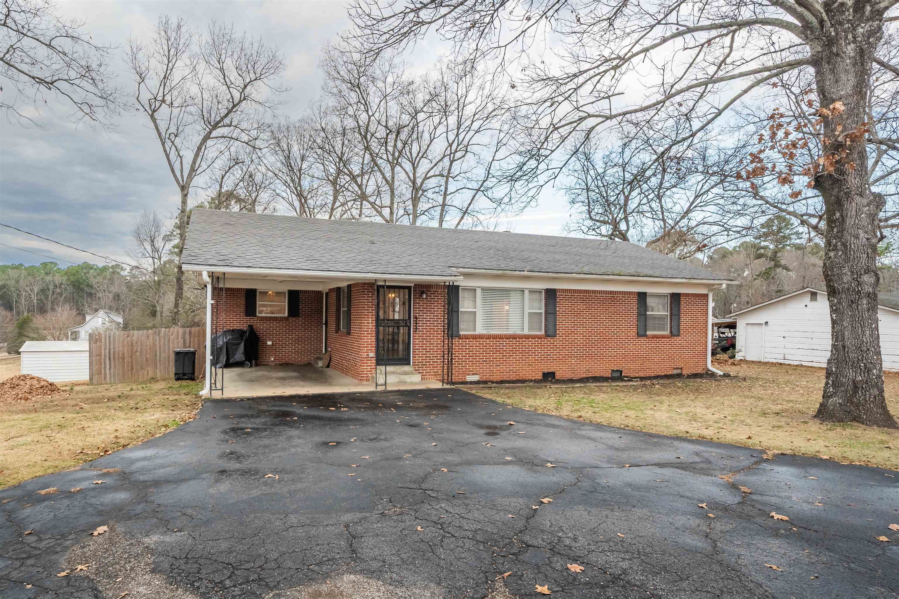 715 Burns Road Ramer, TN 38367 - Photo 6 of 20 Ranch-style house featuring a carport, brick siding, asphalt driveway, crawl space, and roof with shingles