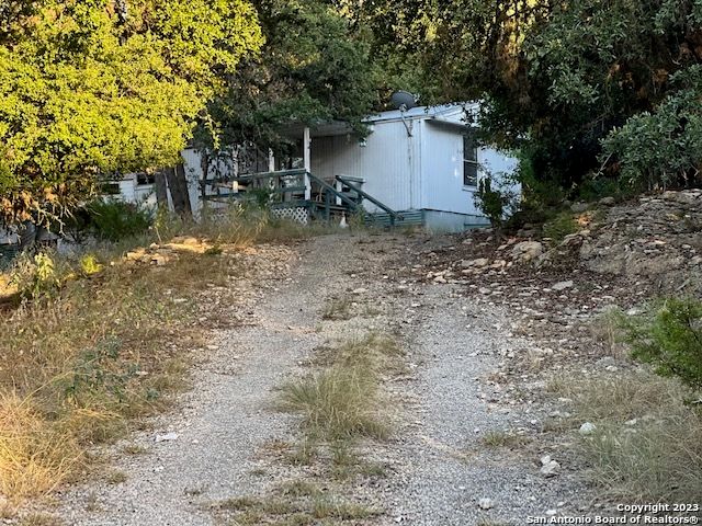 a view of a house with a yard and sitting area