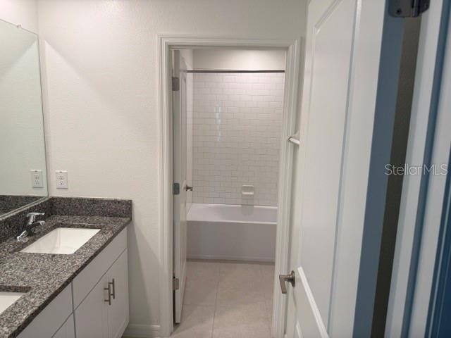 6259 Back Forty Loop Zephyrhills, FL 33541 - Photo 10 of 22 a bathroom with a granite countertop sink and mirror with bathtub