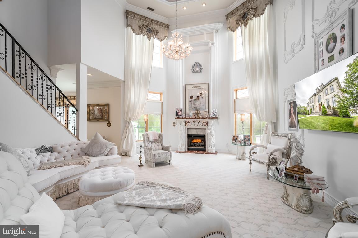 6779 Keller Lime Plant Road Frederick, MD 21703 - Photo 16 of 74 a living room with furniture a fireplace and a chandelier