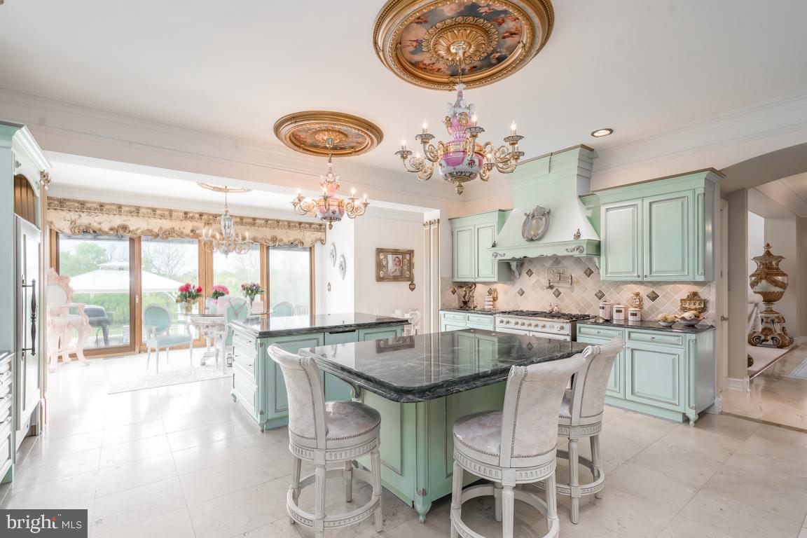 6779 Keller Lime Plant Road Frederick, MD 21703 - Photo 19 of 74 a dining room with wooden floor a chandelier a wooden table and chairs