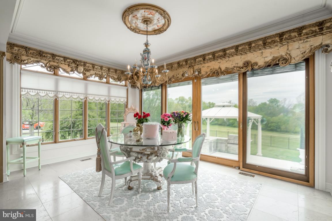 6779 Keller Lime Plant Road Frederick, MD 21703 - Photo 26 of 74 a view of a dining room with furniture wooden floor and chandelier