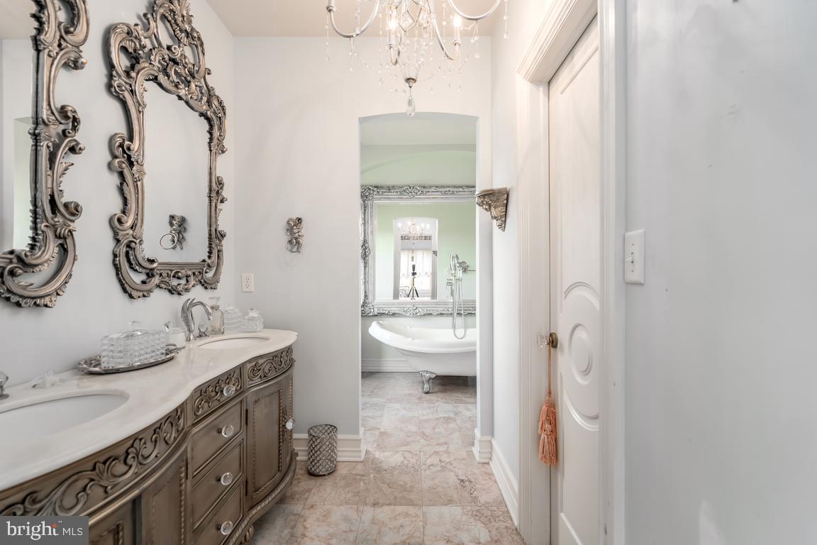 6779 Keller Lime Plant Road Frederick, MD 21703 - Photo 53 of 74 a spacious bathroom with a double vanity sink a mirror and a bathtub