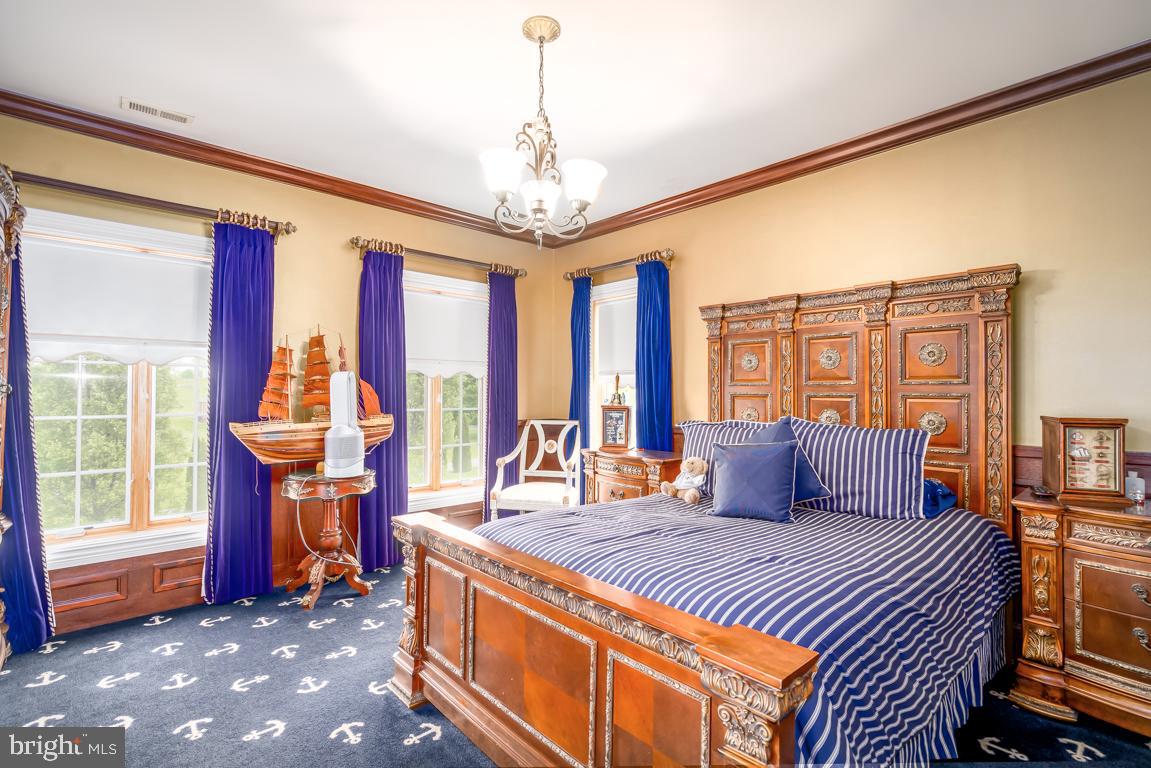 6779 Keller Lime Plant Road Frederick, MD 21703 - Photo 55 of 74 a bedroom with a large bed and large windows