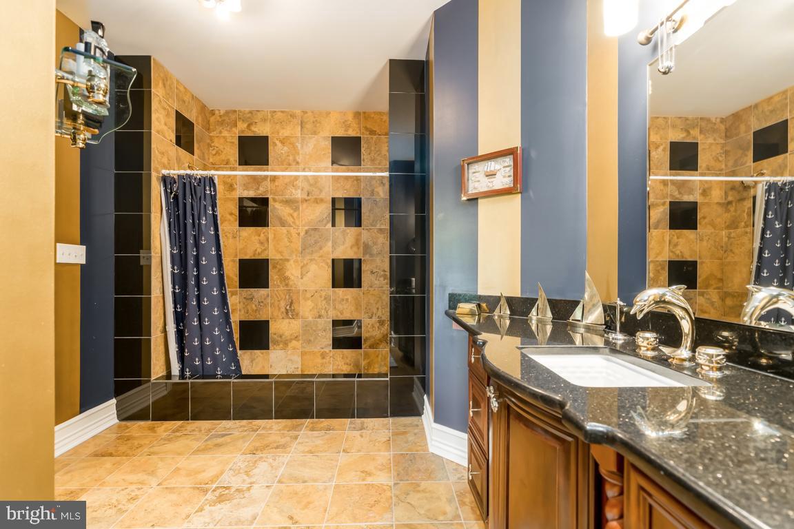 6779 Keller Lime Plant Road Frederick, MD 21703 - Photo 58 of 74 a bathroom with a granite countertop sink and a mirror